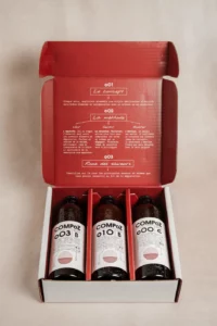 Trois bouteilles de bière Compoz dans leur coffret